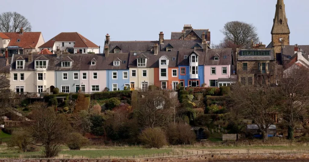 Alnmouth colourful coastal cottages by the sea.