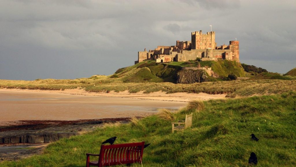 Wide sandy beach beneath Bamburgh Castle.