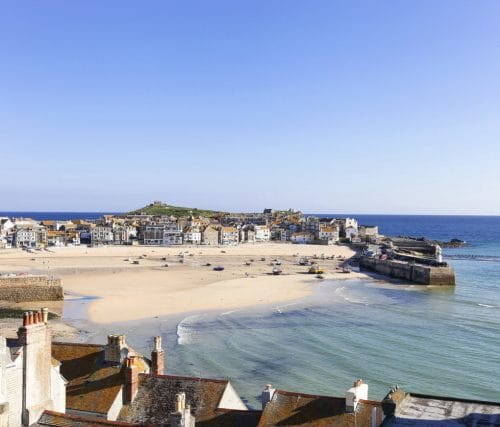 St Ives harbour in Cornwall with the tide out exposing the sandy beach.