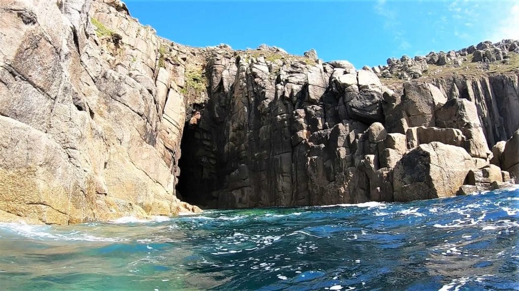 Rocky cave opening by the sea.