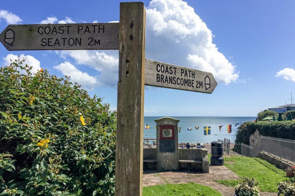 Sign post showing the coastal path to Branscombe in Devon with sea views.