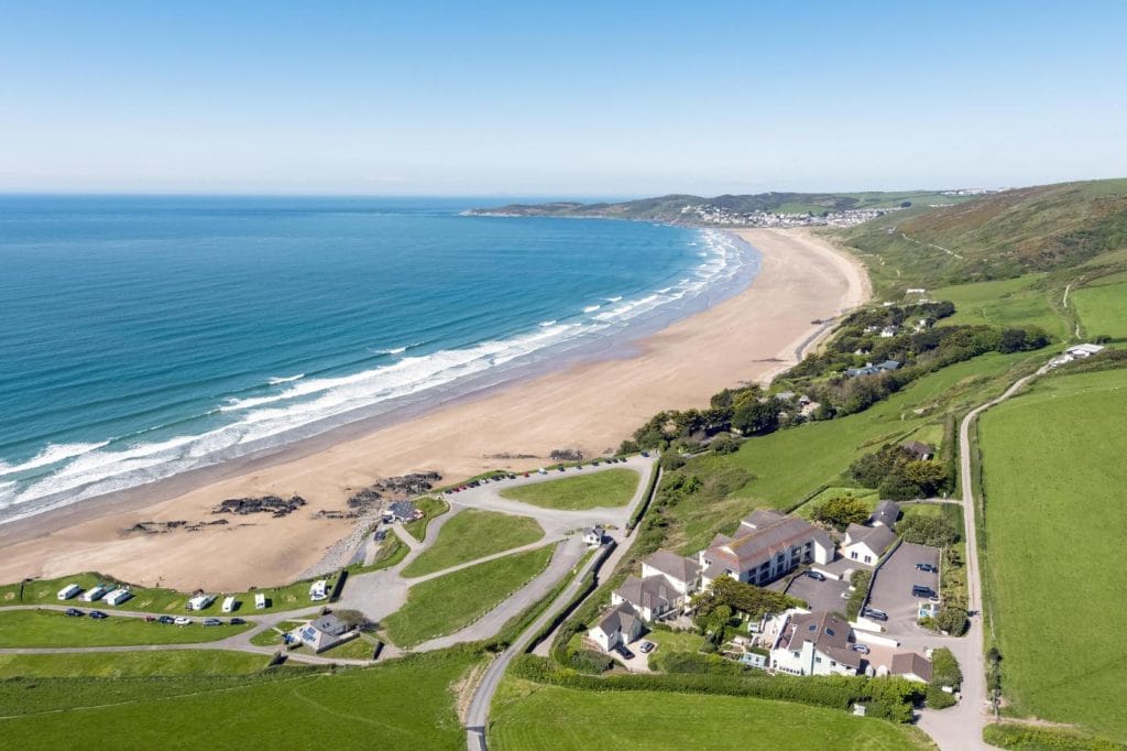 Long sweeping view of the popular surf beach at Croyde.