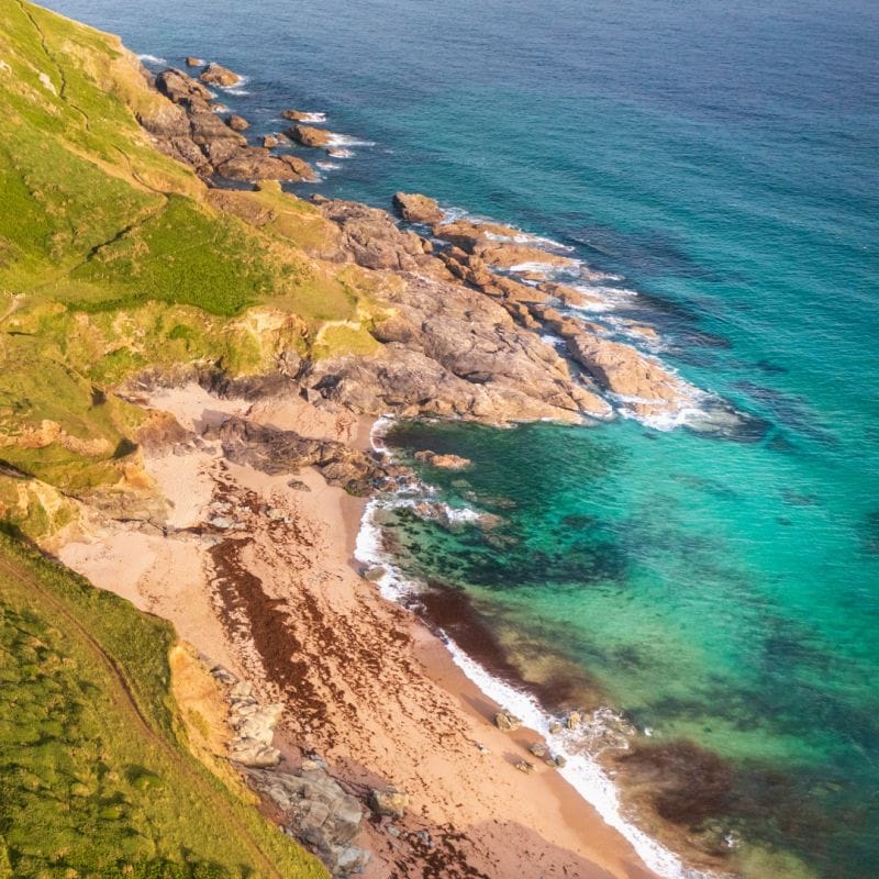 Aerial view of the sea and Gara Rock near Salcombe, Devon.