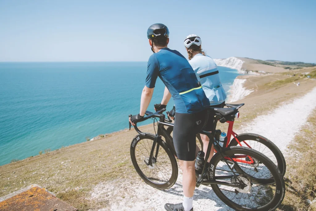 Couple cycling by the sea IOW