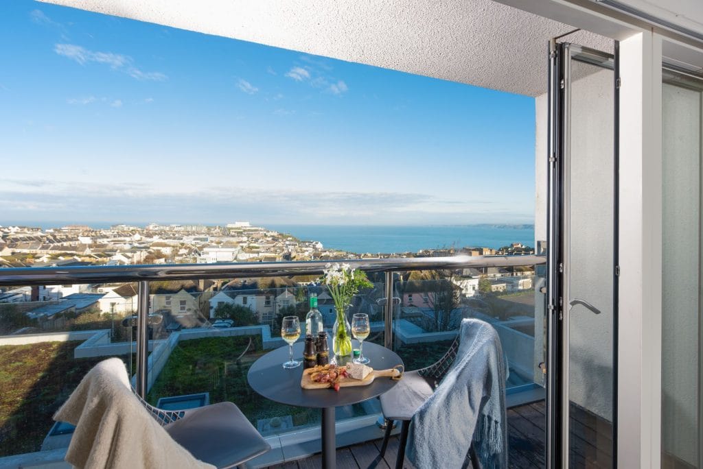 Newquay holiday home that sleeps 8 with private roof terrace and sea views.