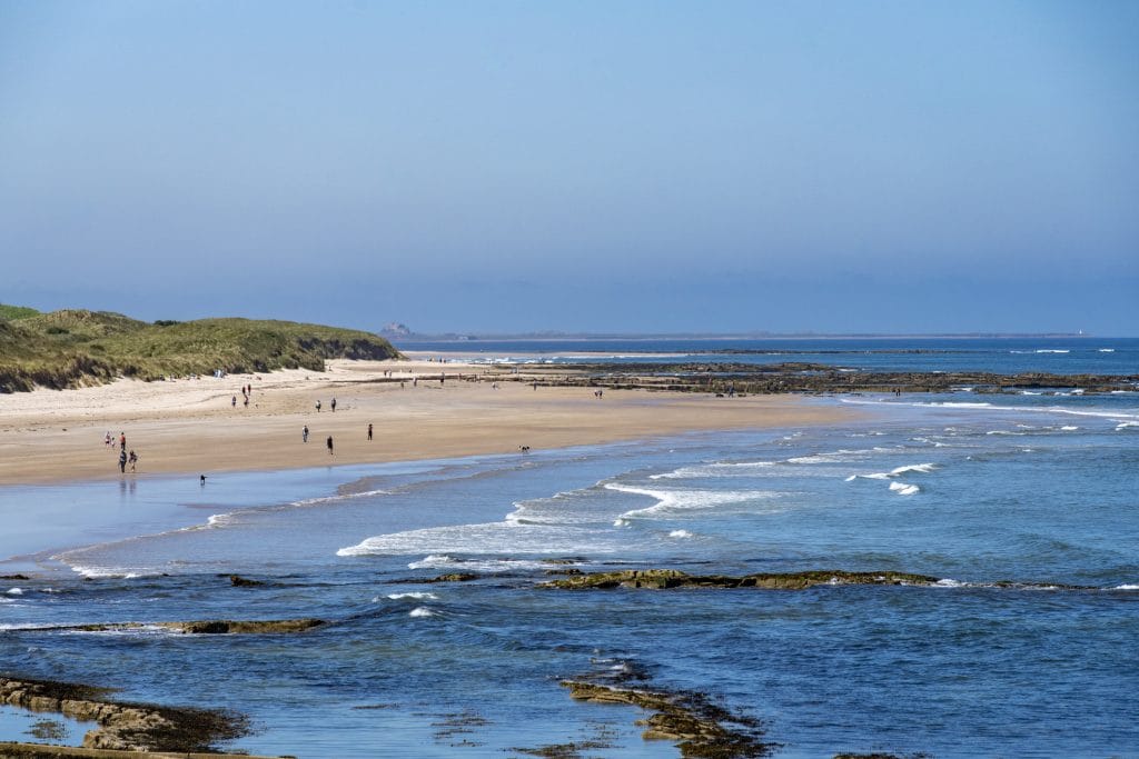 Seahouses beach with views towards Bamburgh Castle in the distance