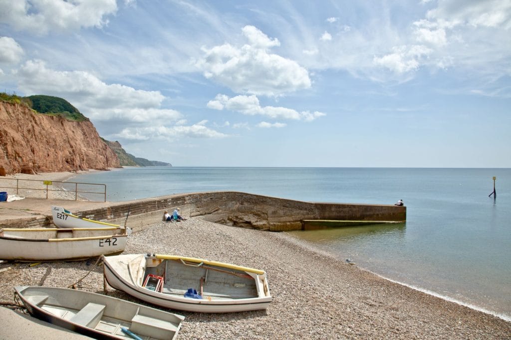 Boats on the shore at Sidmouth Beach in Devon.