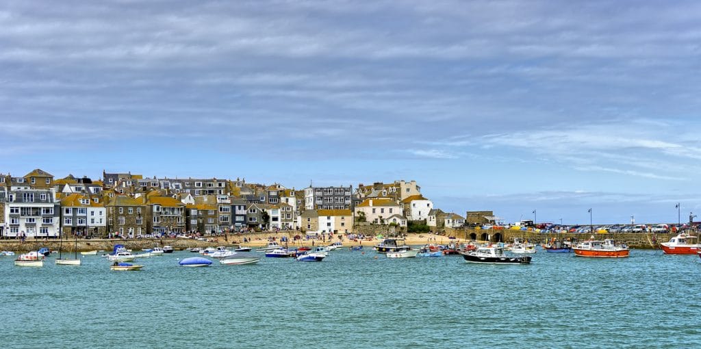 St Ives harbour in winter with fishing boats and pastel cottages under soft light