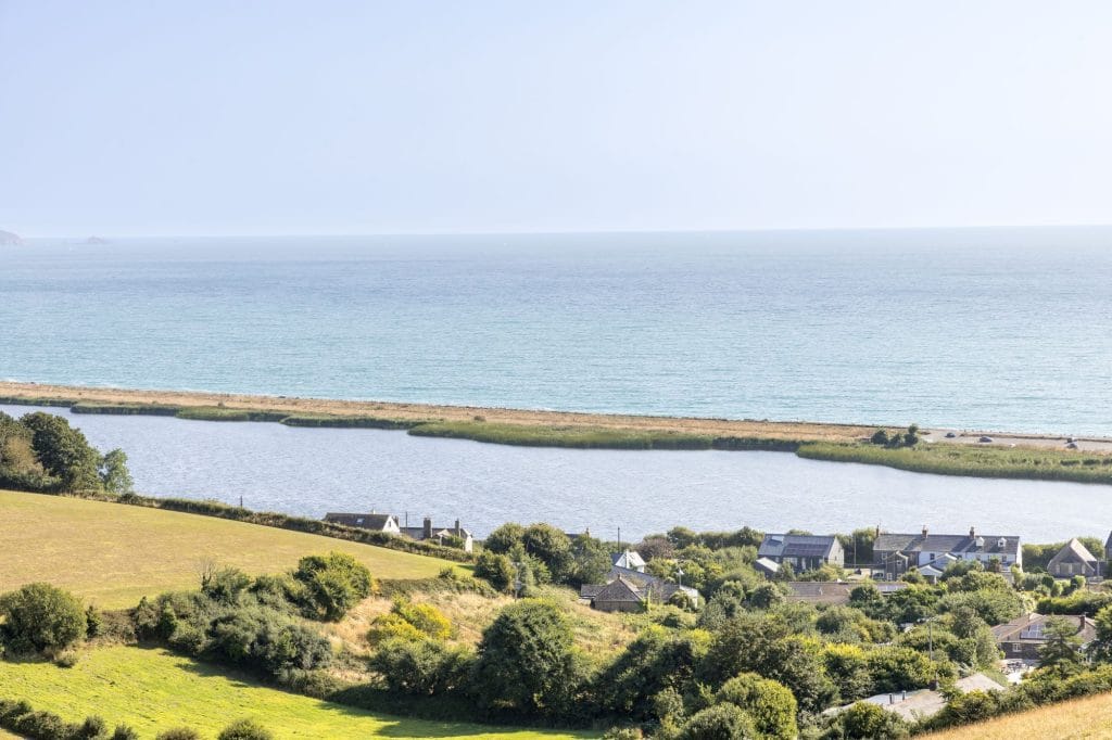 Slapton Sands beach in Torcross showing cottages by the sea.
