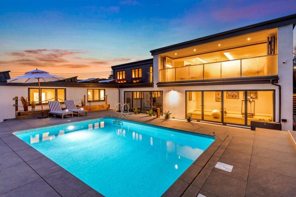 Isle of Wight luxury beach house with private pool at night.