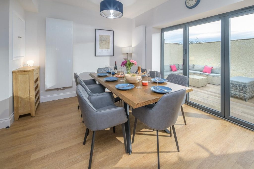Bamburgh group accommodation with large dining table and outdoor terrace