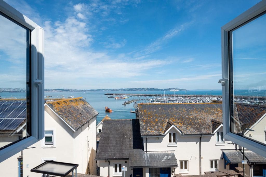 Brixham holiday home with sea views above the roofs