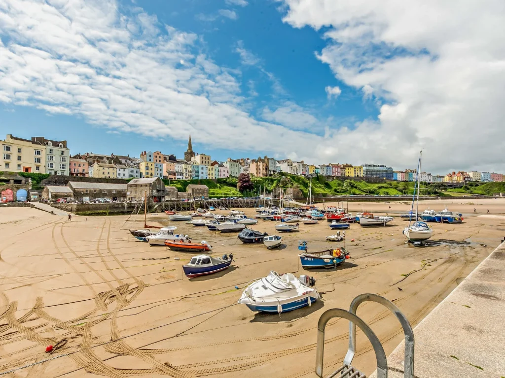 Many boats on the sandy beach at Tenby on a sunny day
