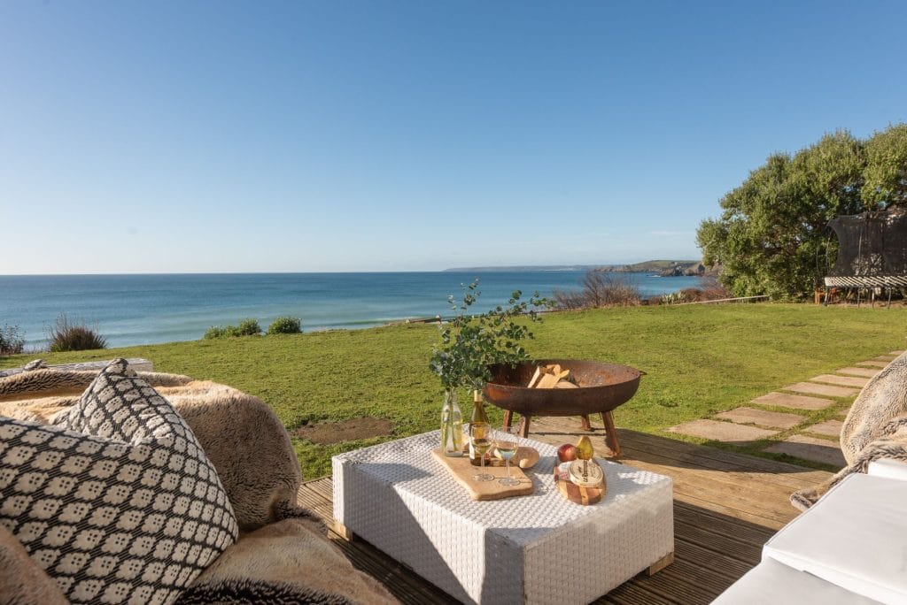 Beachfront garden with fire-pit, outdoor furniture and sea views