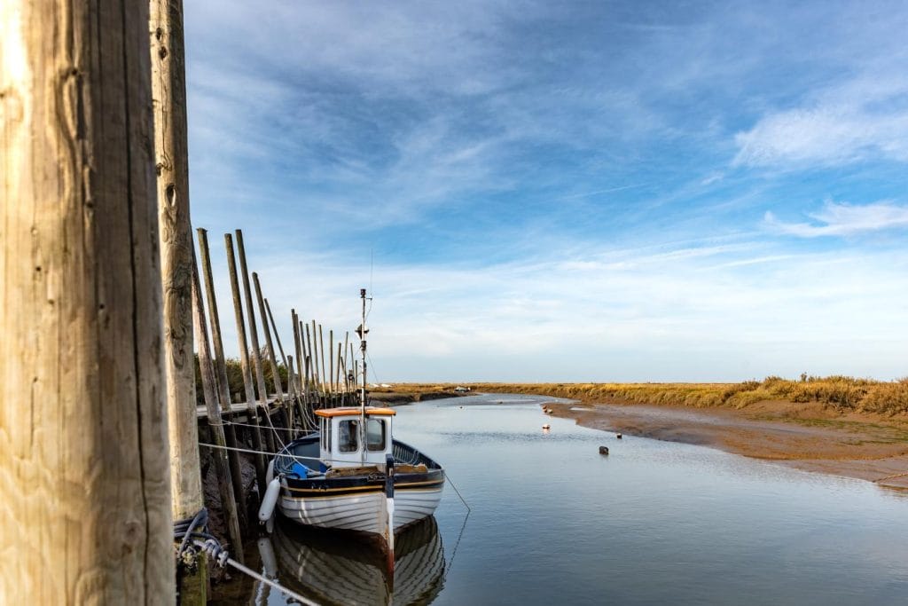 Blakeney estuary with boat moored on a sunny day