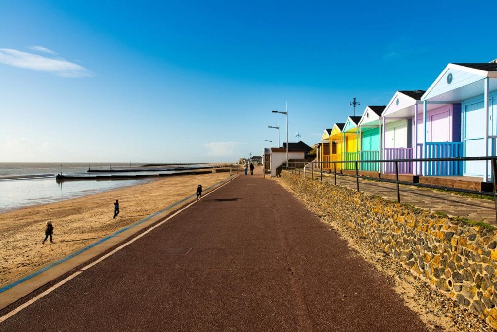 Colourful beach huts lining the shore at Kessingland in Suffolk