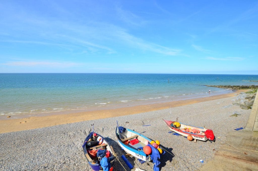 Boats moored on the shingle and sand beach at Sheringham
