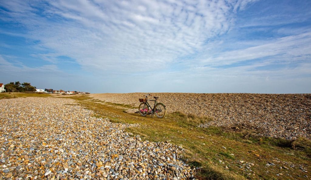 Bike parked on the shingle beach at Thorpeness in Suffolk