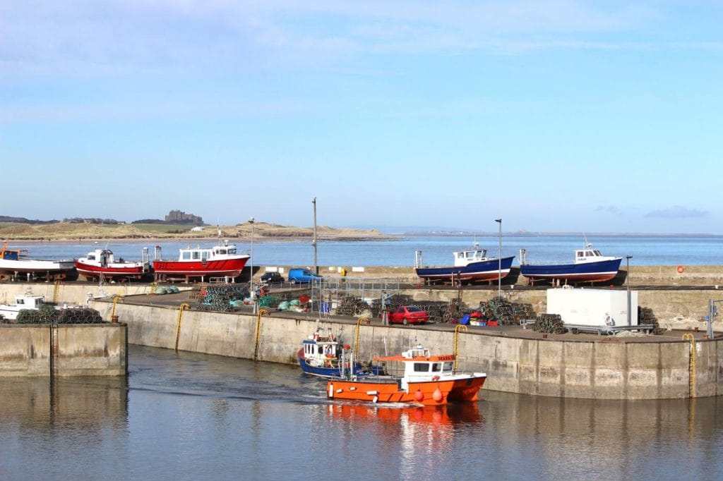 A boat leaving the harbour at Seahouses in Northumberland