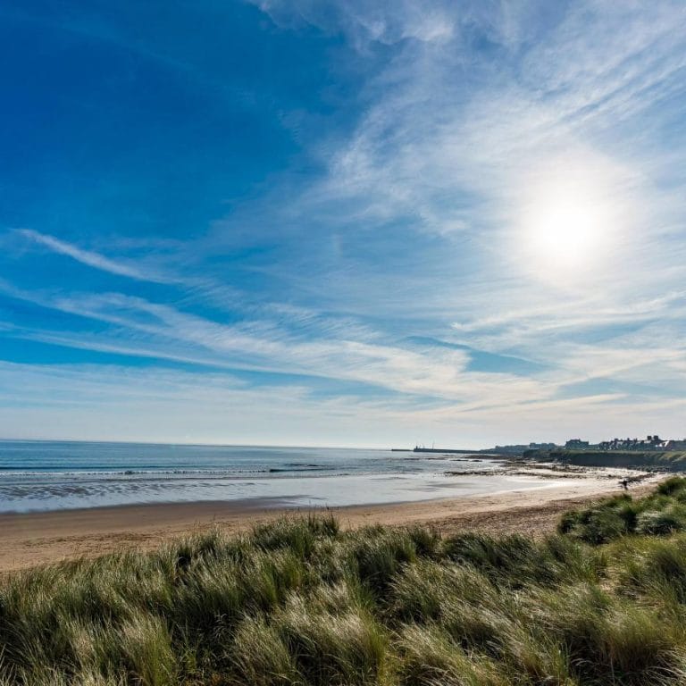 Late afternoon view across the sandy beach at Seahouses in Northumberland
