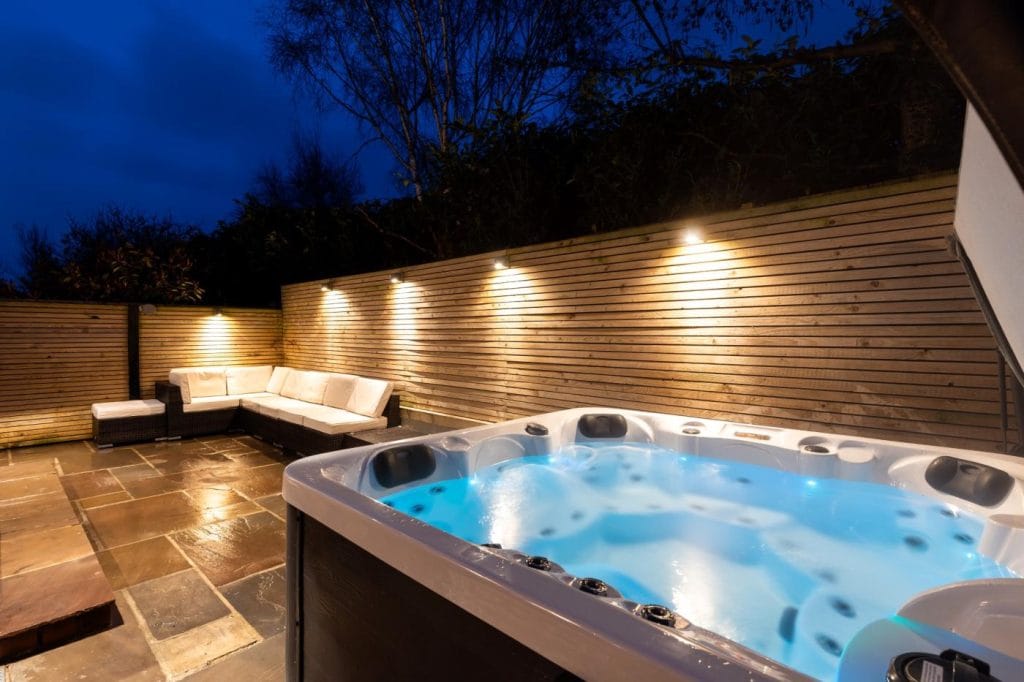 Hot tub under lights in a Yorkshire holiday cottage