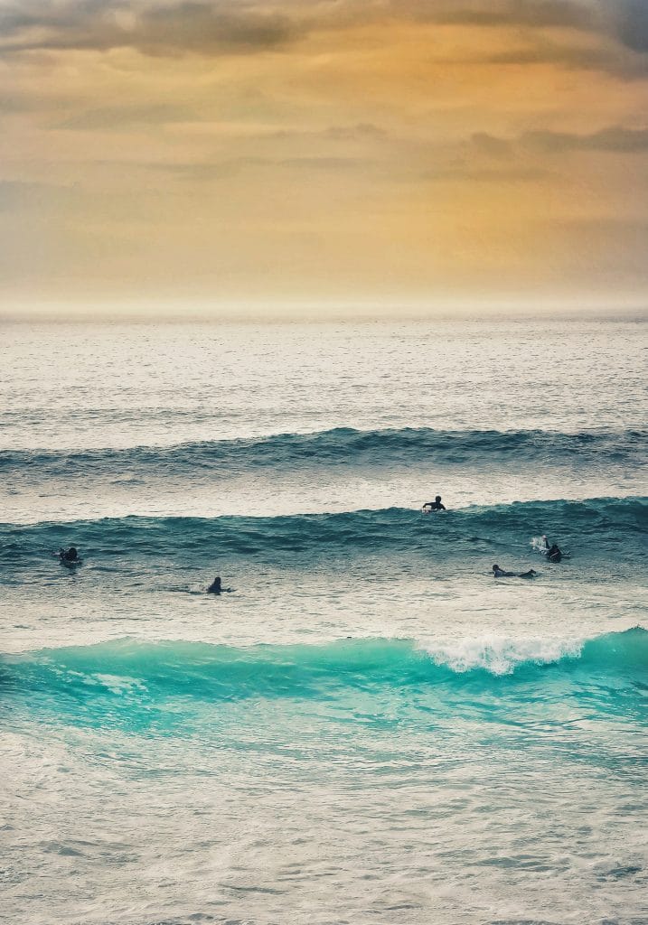Group of surfers catching waves on Fistral Beach, Newquay