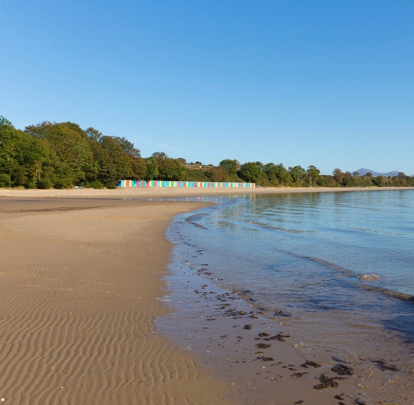 Colourful beach huts on Llanbedrog beach