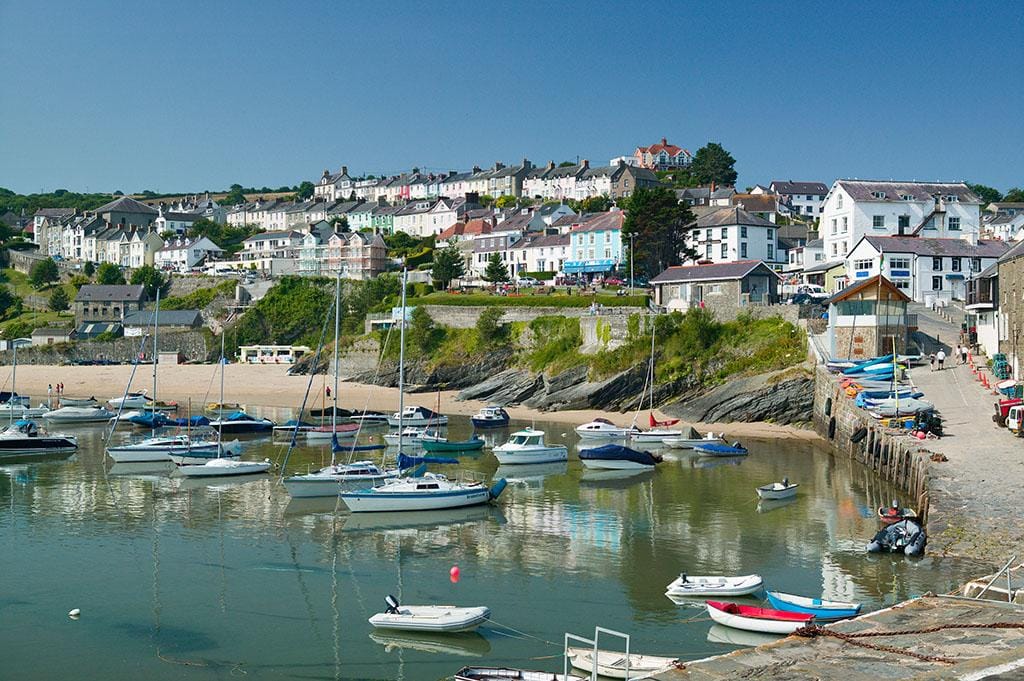 Boats moored in New Quay harbour and beach