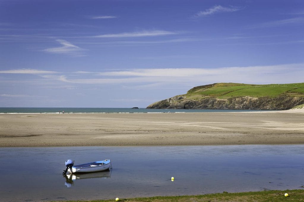 Small boat in the estuary by the sea in Newport