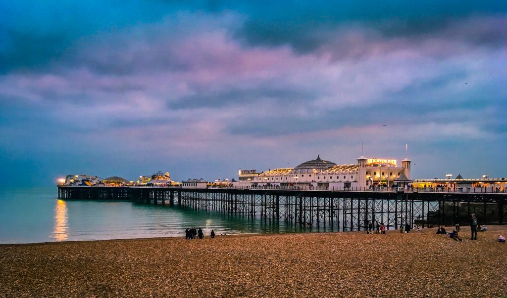 Brighton Pier with the lights on at dusk, Sussex