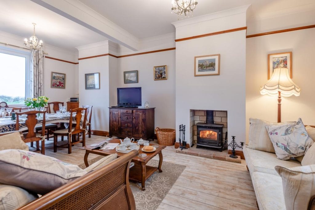 Cottage living room with log fire by the sea in Norfolk.