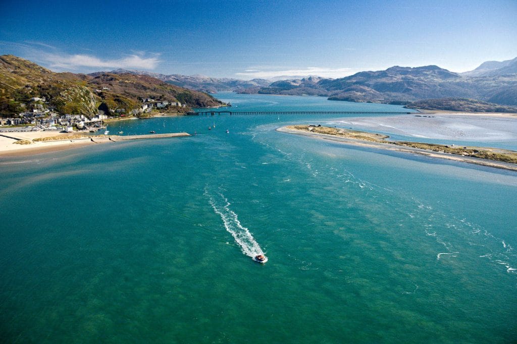 Boat leaving the harbour from Barmouth on a sunny day