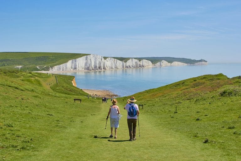 Coastal walkers overlooking the Seven Sisters in East Sussex