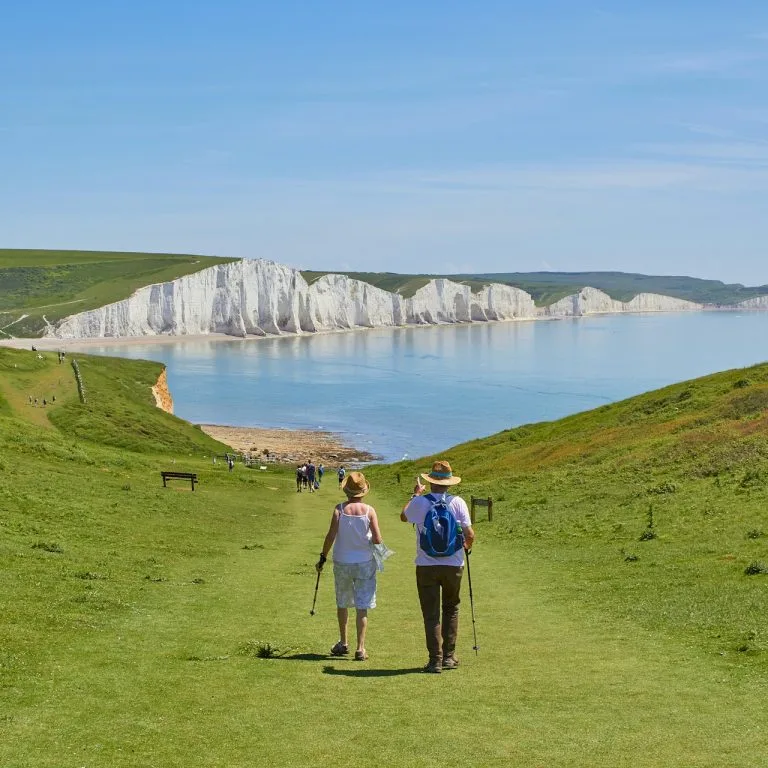 Coastal walkers overlooking the Seven Sisters in East Sussex