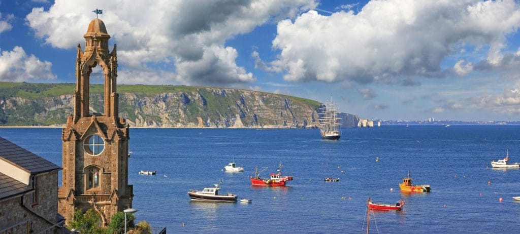 Boats moored off the beach at Swanage on a cloudy day
