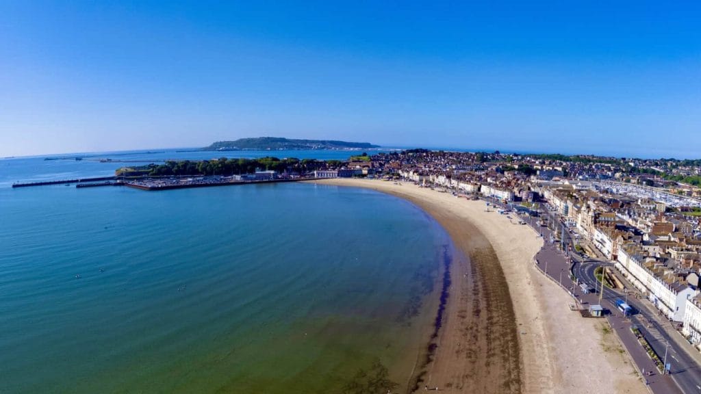 The long sandy beach at Weymouth at high tide