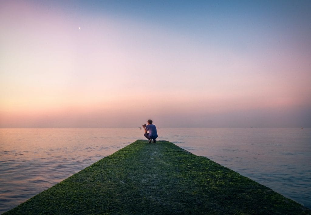 A lone traveller staring at the horizon in Brighton, East Sussex