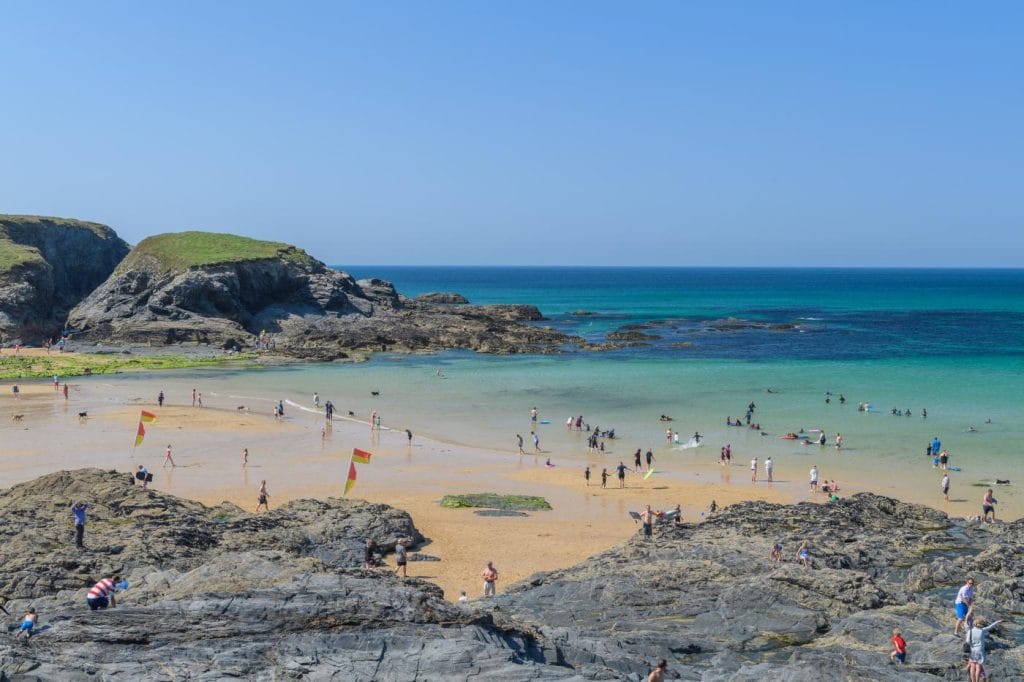 People enjoying the gently shelving beach at Harlyn Bay