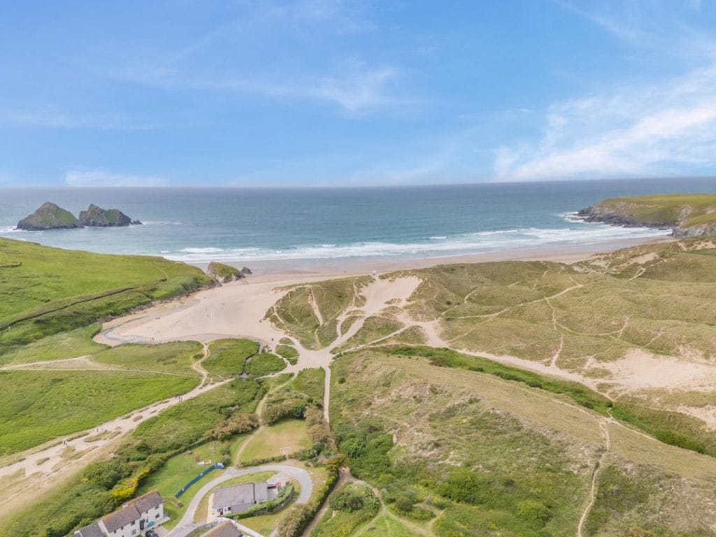 The dune system at Holywell Bay with the sea in the background