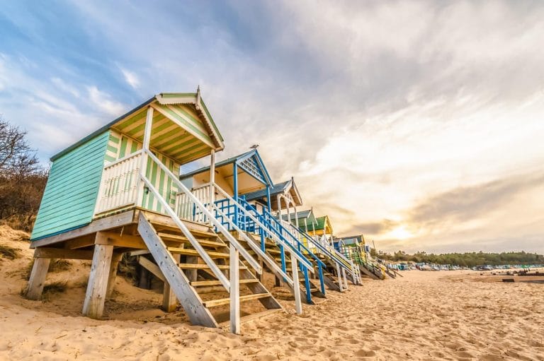 Colourful beach huts on the sand in Norfolk