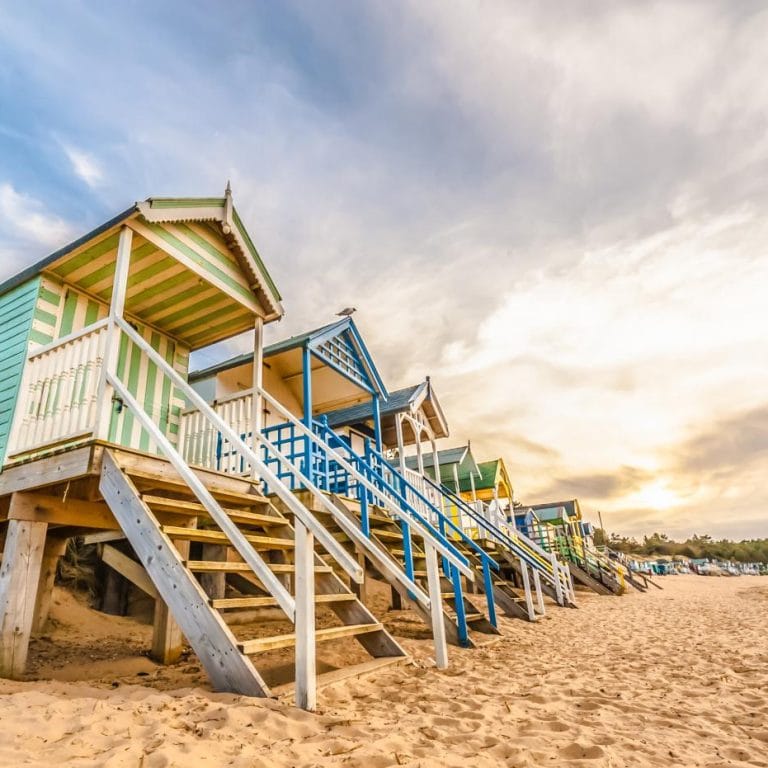 Colourful beach huts on the sand in Norfolk