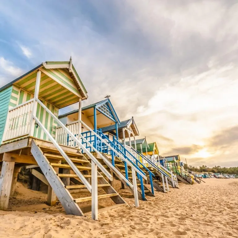 Colourful beach huts on the sand in Norfolk