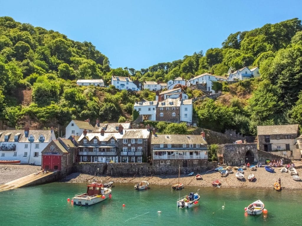 Clovelly town and harbour with boats moored in the water