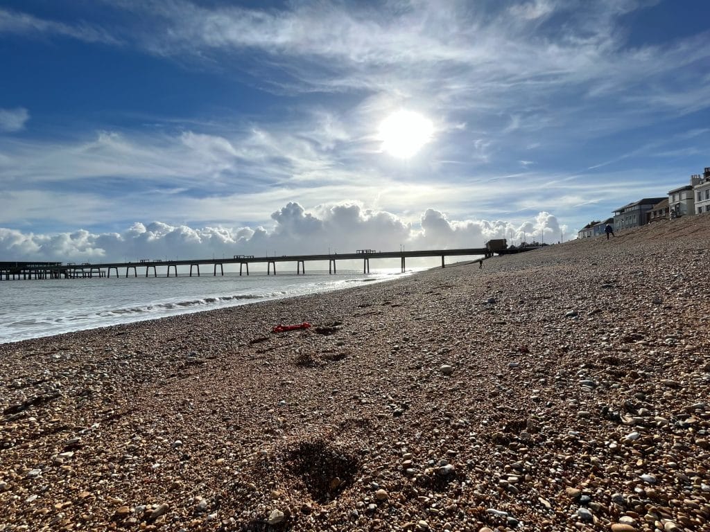 The pier and pebble beach at Deal in Kent at sunset.
