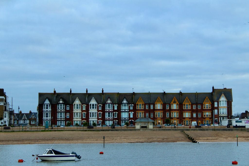 A boat floating in the sea opposite the beach at Herne Bay in Kent.