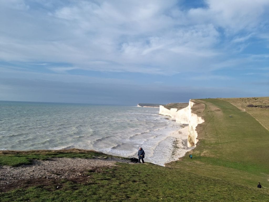 Walking a dog on the coastal path at Seven Sisters in Sussex