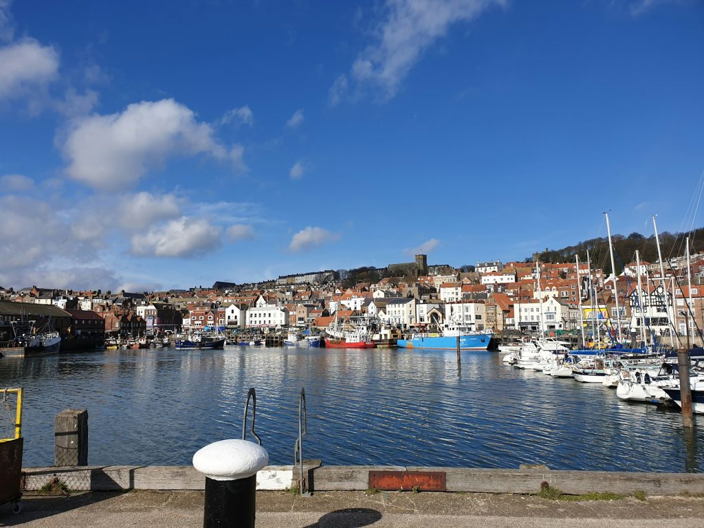 Boats and seafront cottages at Scarborough harbour, Yorkshire.