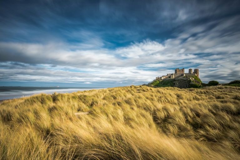 Picturesque view of Bamburgh Castle overlooking the beach on the Northumberland Coast.