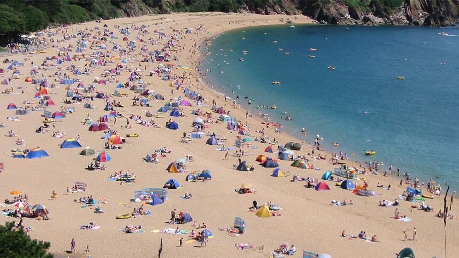 Lots of people on Blackpool Sands beach in summer.