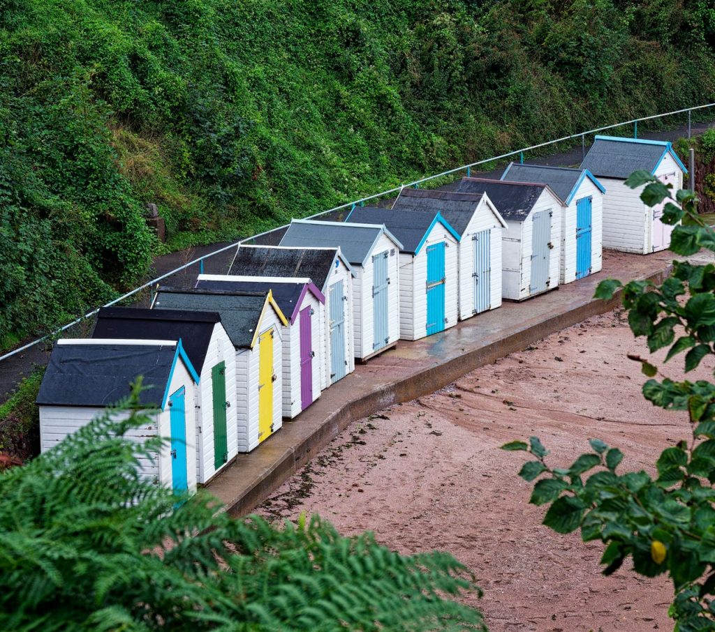 Row of colourful beach huts at Broadsands Beach, Paignton.